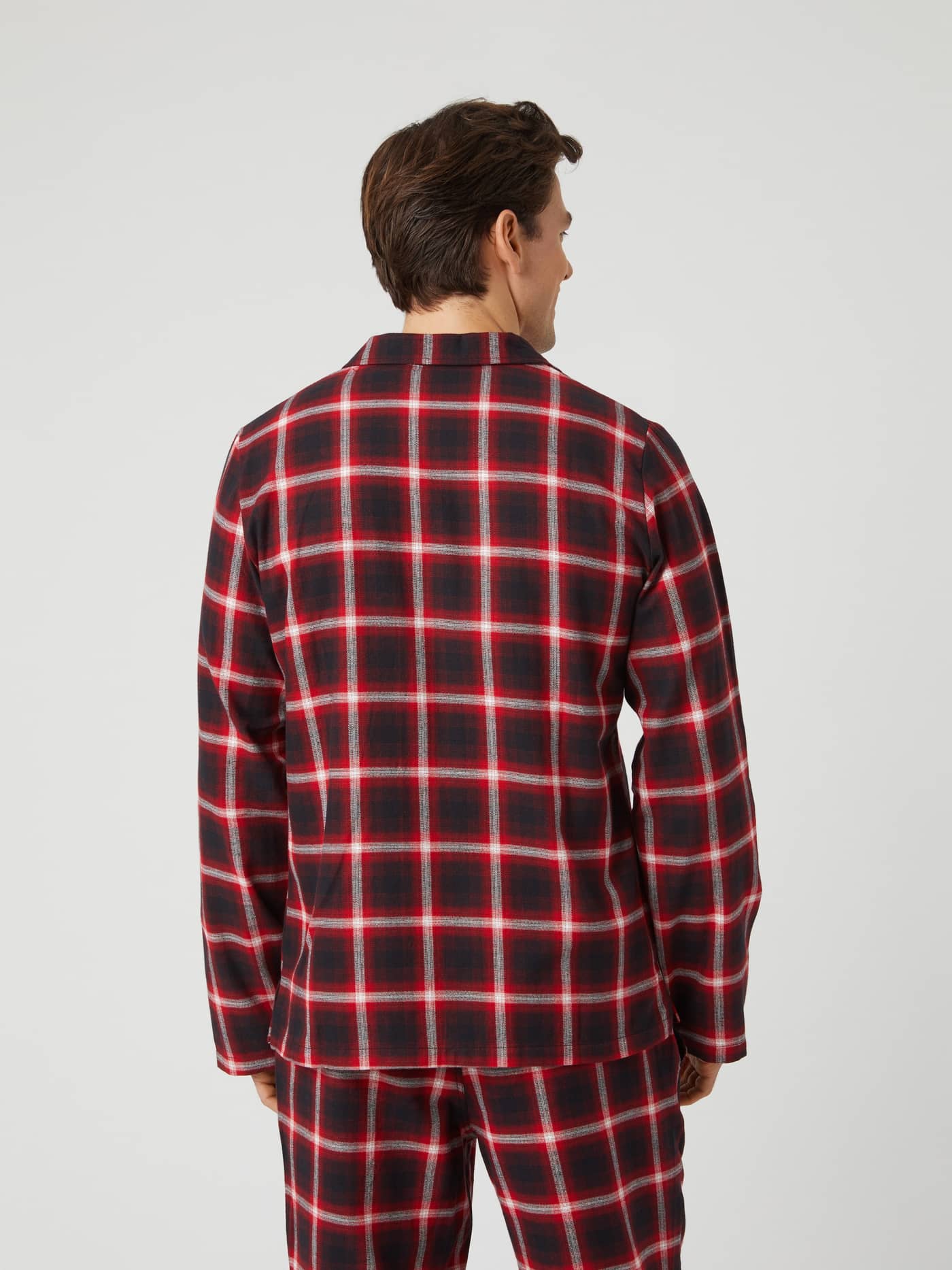 Back view of a model wearing the Björn Borg Core Flannel Pyjama Shirt in a red and black lumber check. - Image 2