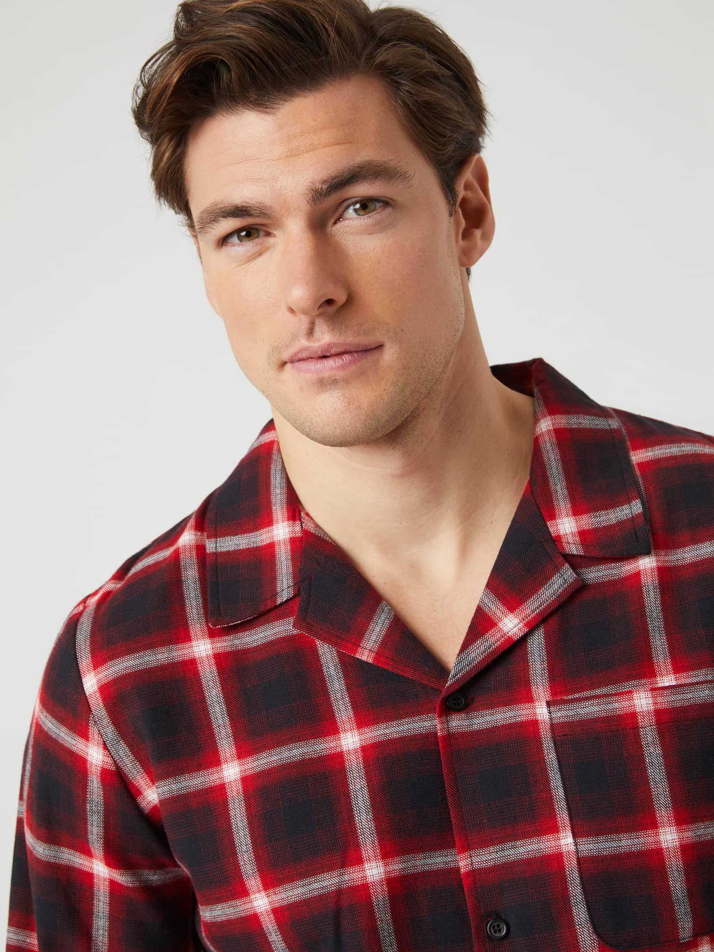Close-up of a male model wearing the red and black checked Björn Borg Core Flannel Pyjama Shirt. - Image 4