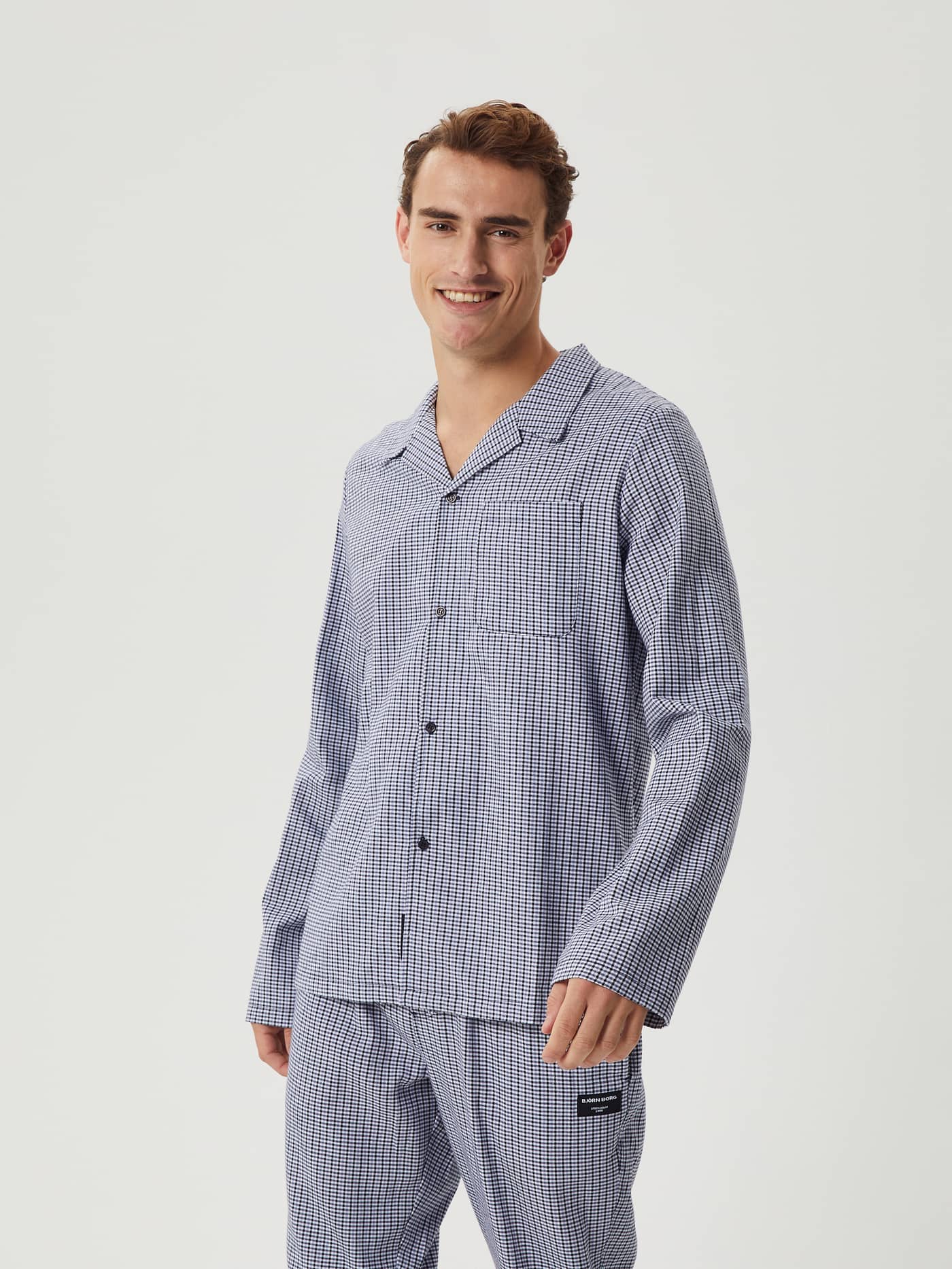 Male model seen from the front wearing the Björn Borg Core Flannel Pyjama Shirt in a blue and white check pattern. - Image 1