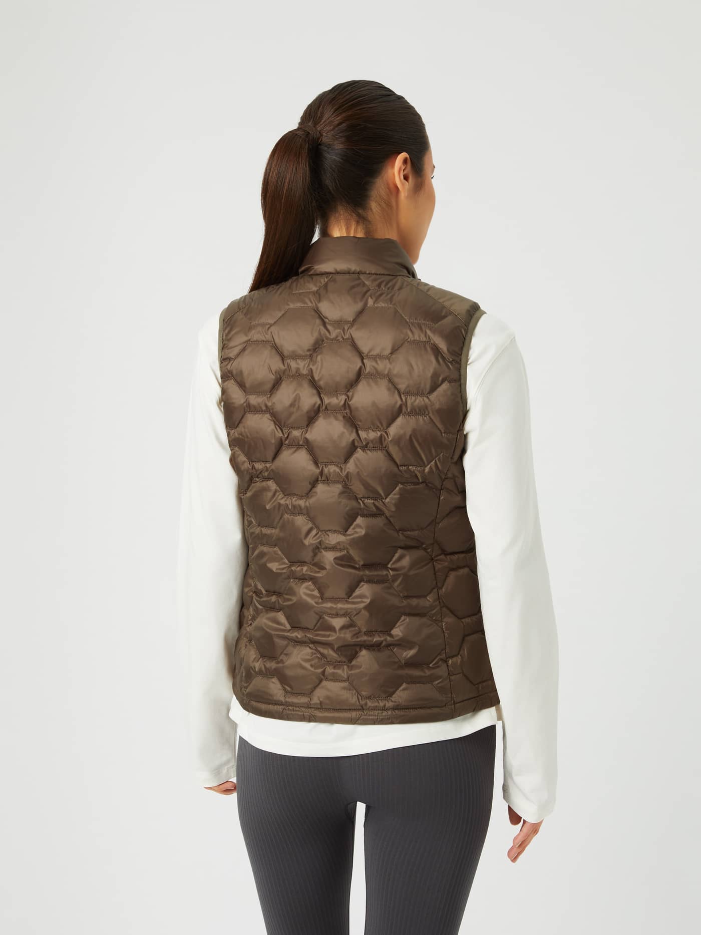 Back view of a model wearing the quilted Borg Down Liner Vest in Tarmac (Brown), highlighting its regular fit. - Image 4