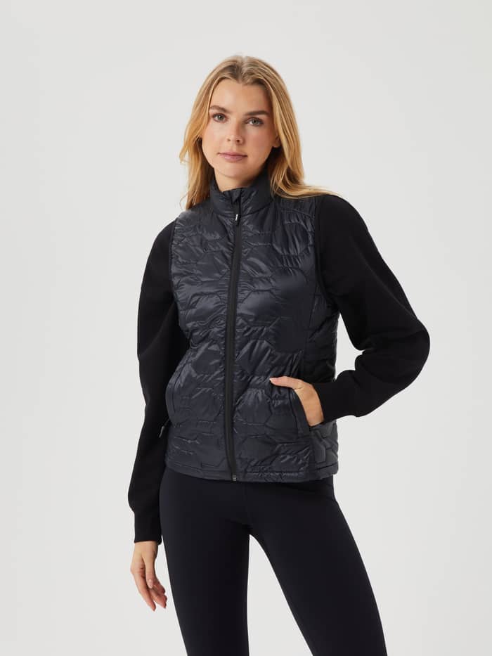 Front view of a woman wearing the quilted Borg Down Liner Vest in Black Beauty (Black) for a stylish and layered fit. - Image 2