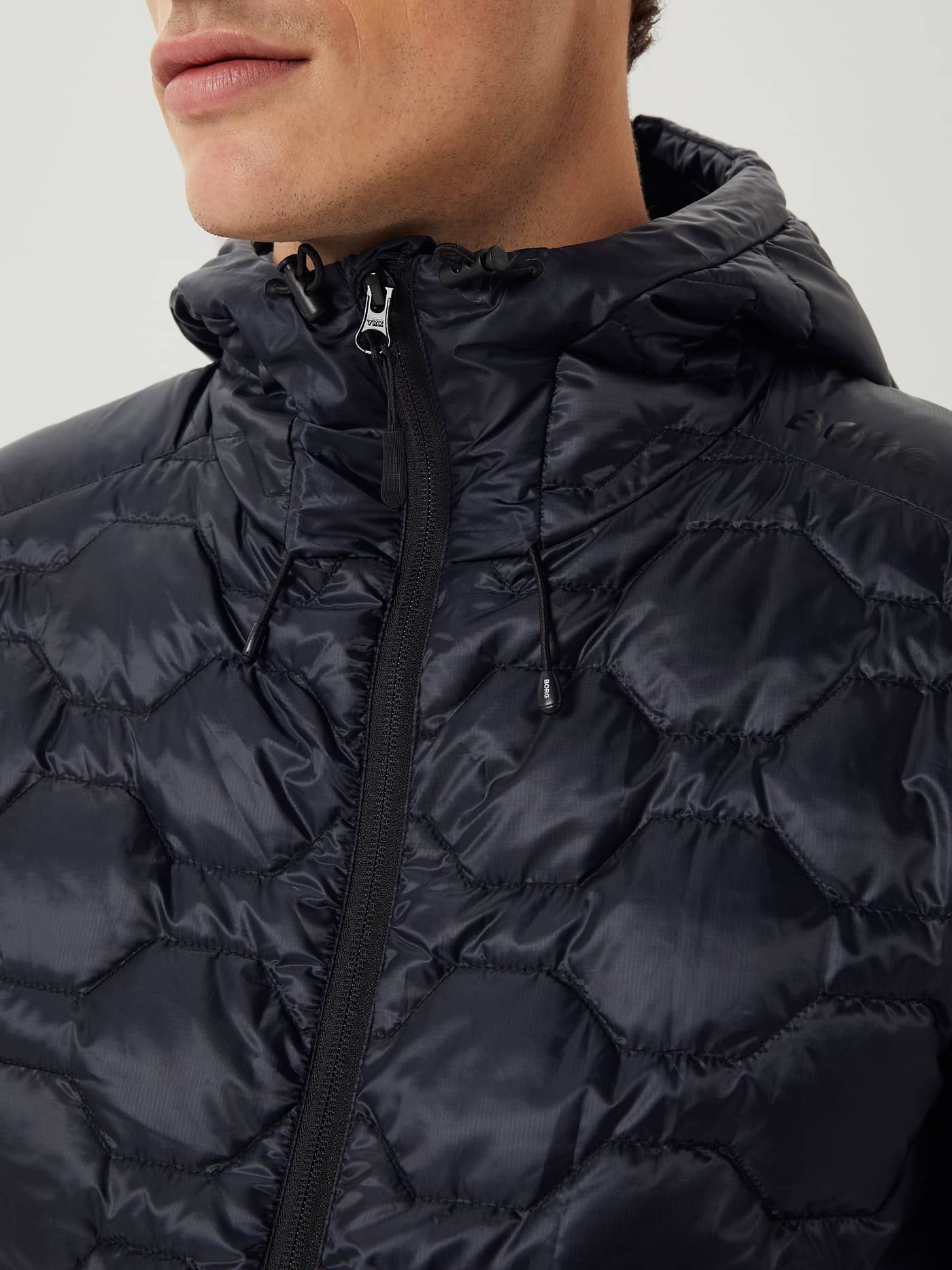 Close-up of the Borg Down Liner Jacket in Black Beauty (Black) featuring a functional quilted ripstop design and hood. - Image 7