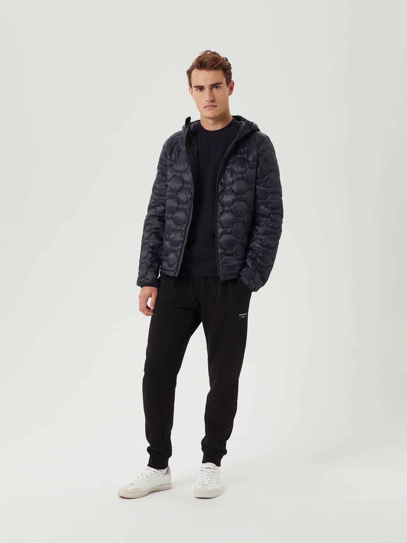 Full-body front view of a man wearing the insulating water-repellent Borg Down Liner Jacket in Black Beauty (Black). - Image 5