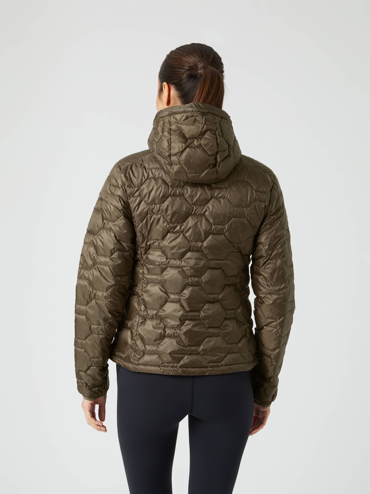 Back view of a woman in the Borg Down Liner Jacket in Tarmac (Brown), a stylish performance layer with a quilted finish. - Image 2