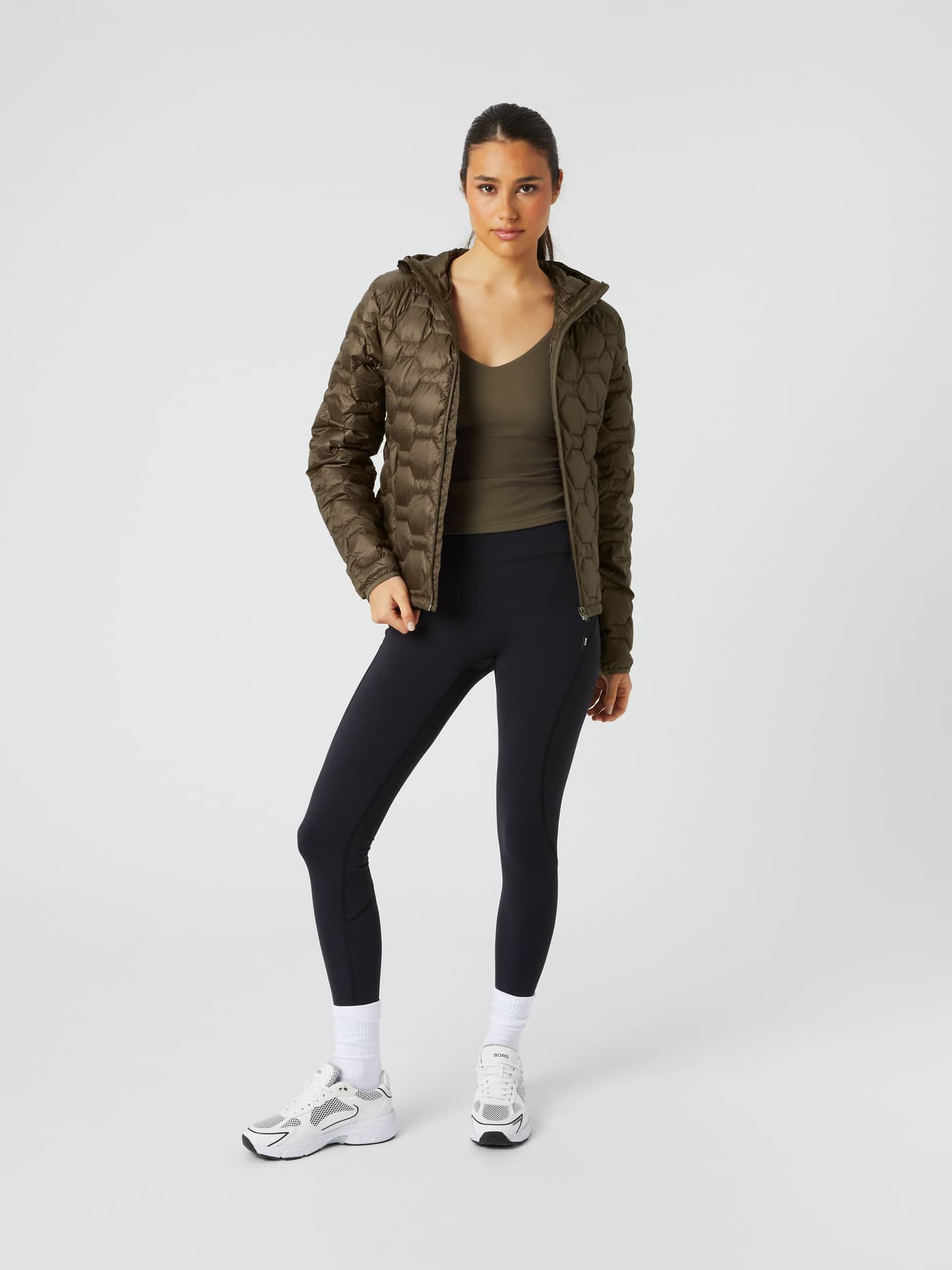 Full-body front view of a woman in the Borg Down Liner Jacket in Tarmac (Brown), featuring a stylish and lightweight fit. - Image 3