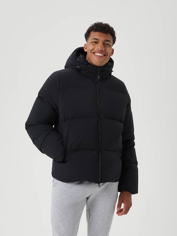 Front view of a man wearing the functional, down-filled Björn Borg Centre Puffer Jacket in Black Beauty (Black). - Image 2
