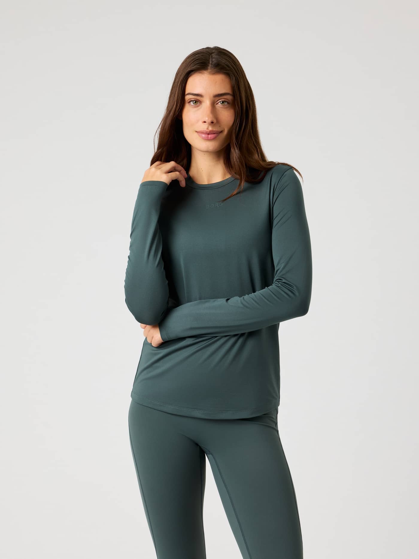 Front view of a model wearing the Borg Long Sleeve T-Shirt in Urban Chic (Green) for stylish women's training. - Image 1