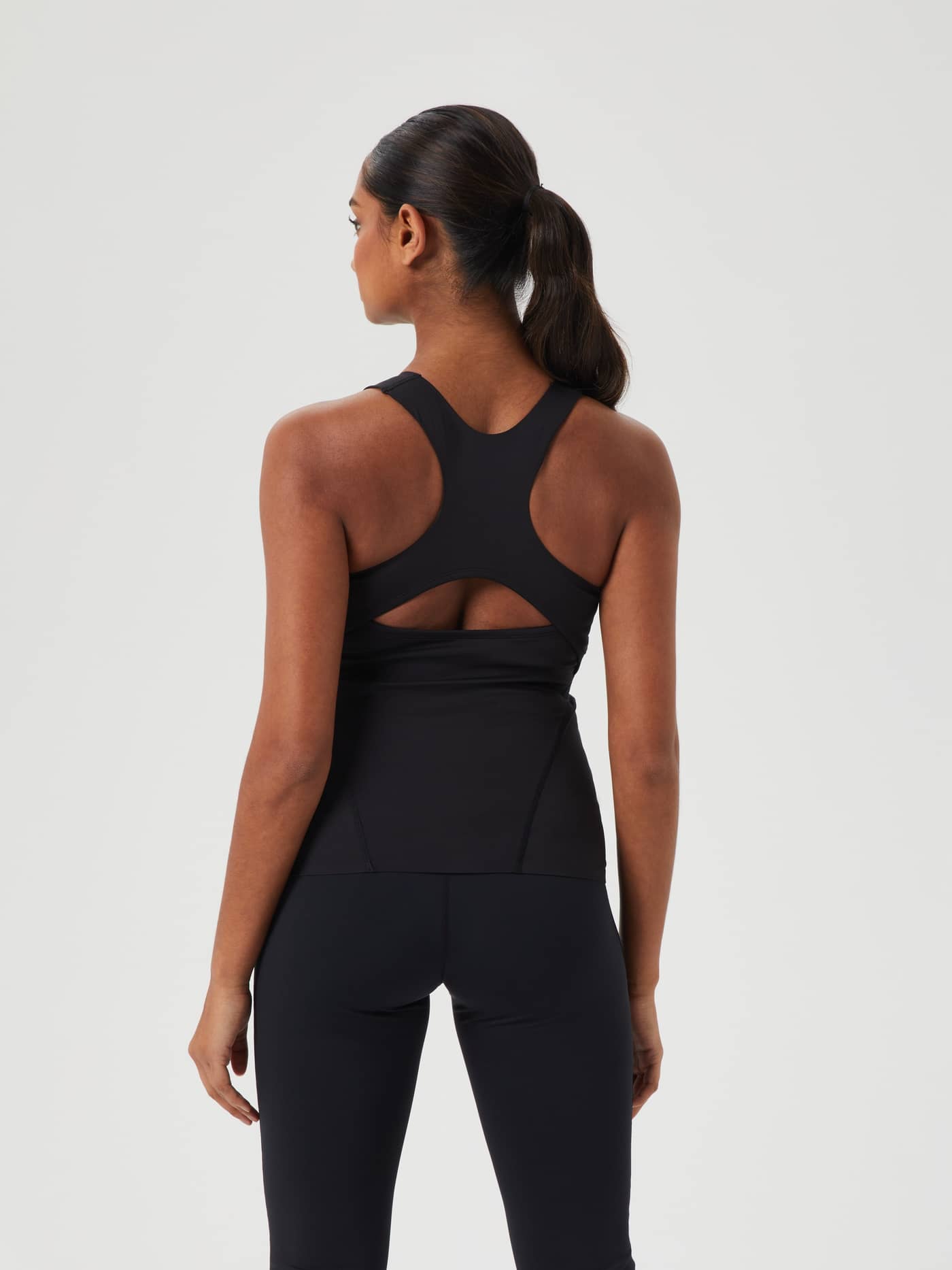 Back view of a model wearing the Björn Borg Studio 2 In 1 Tank in Black Beauty (Black) for training with a racerback. - Image 1