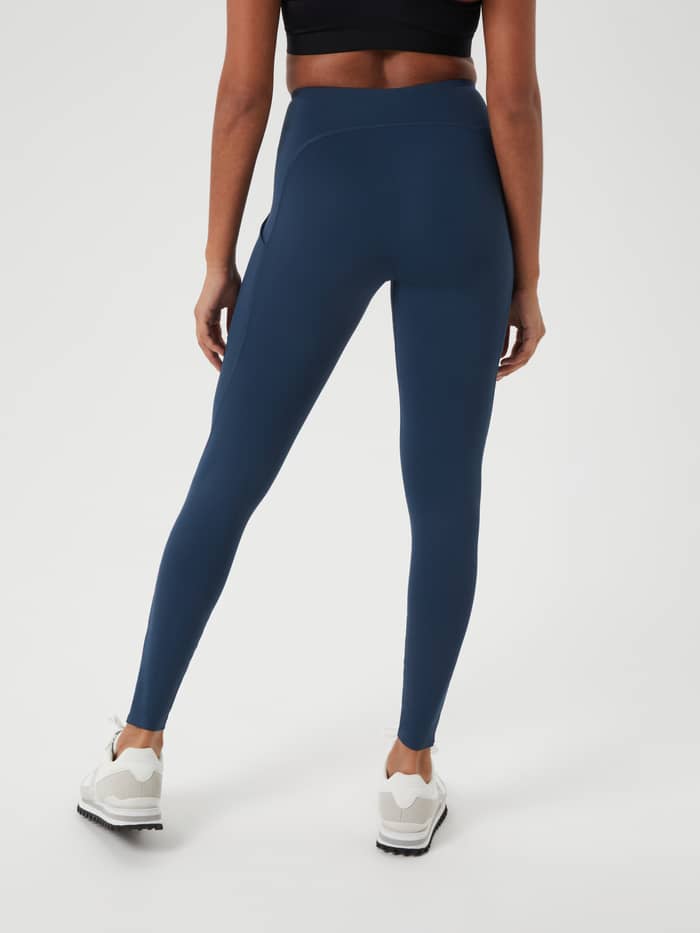 Back view of a woman wearing the slim-fit Borg Reform Premium Tights in Midnight Navy (Navy) for training. - Image 2