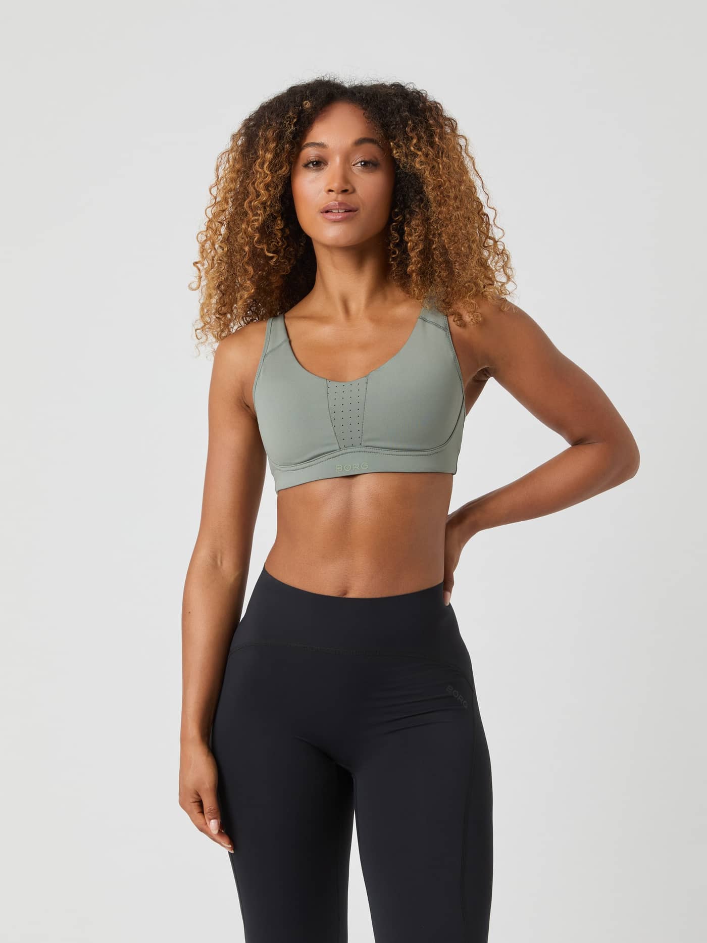 Front view of a woman wearing the Borg Reform Sports Bra in Agave Green. - Image 2