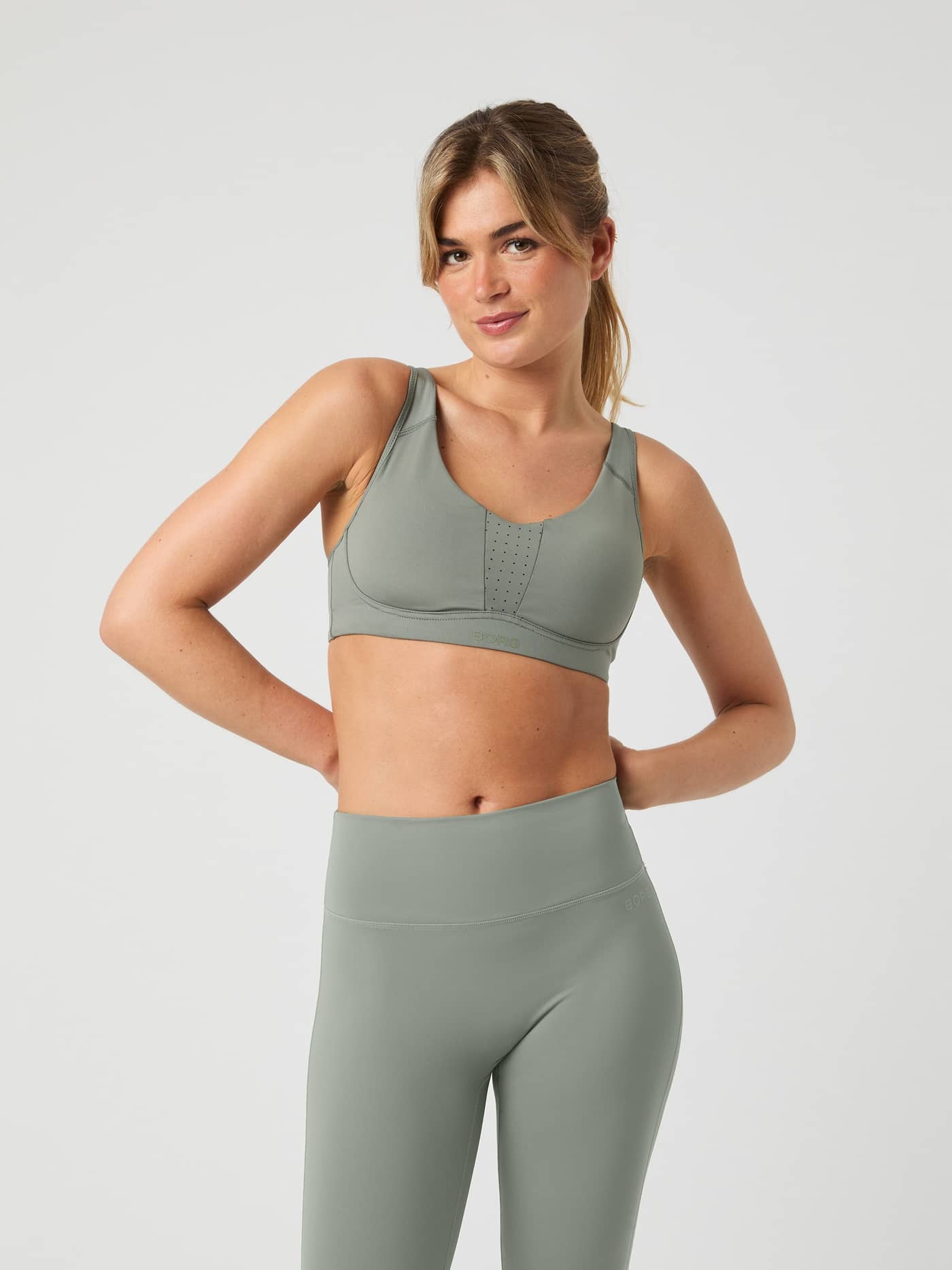 Front view of a model wearing the Borg Reform Sports Bra in Agave Green. - Image 8