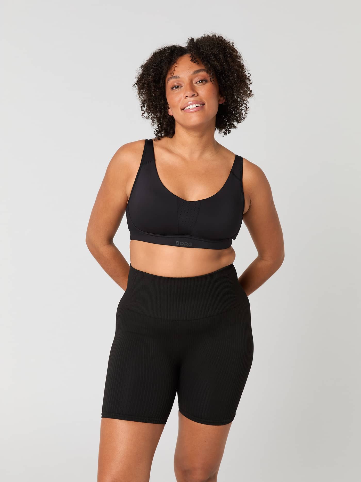 Model seen from the front wearing the black Borg Reform Sports Bra. - Image 9