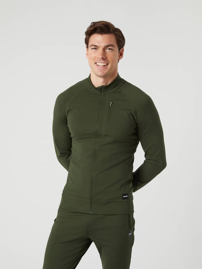 Front view of a man wearing the Borg Training Midlayer Jacket in Duffel Bag (Green), designed for training performance.