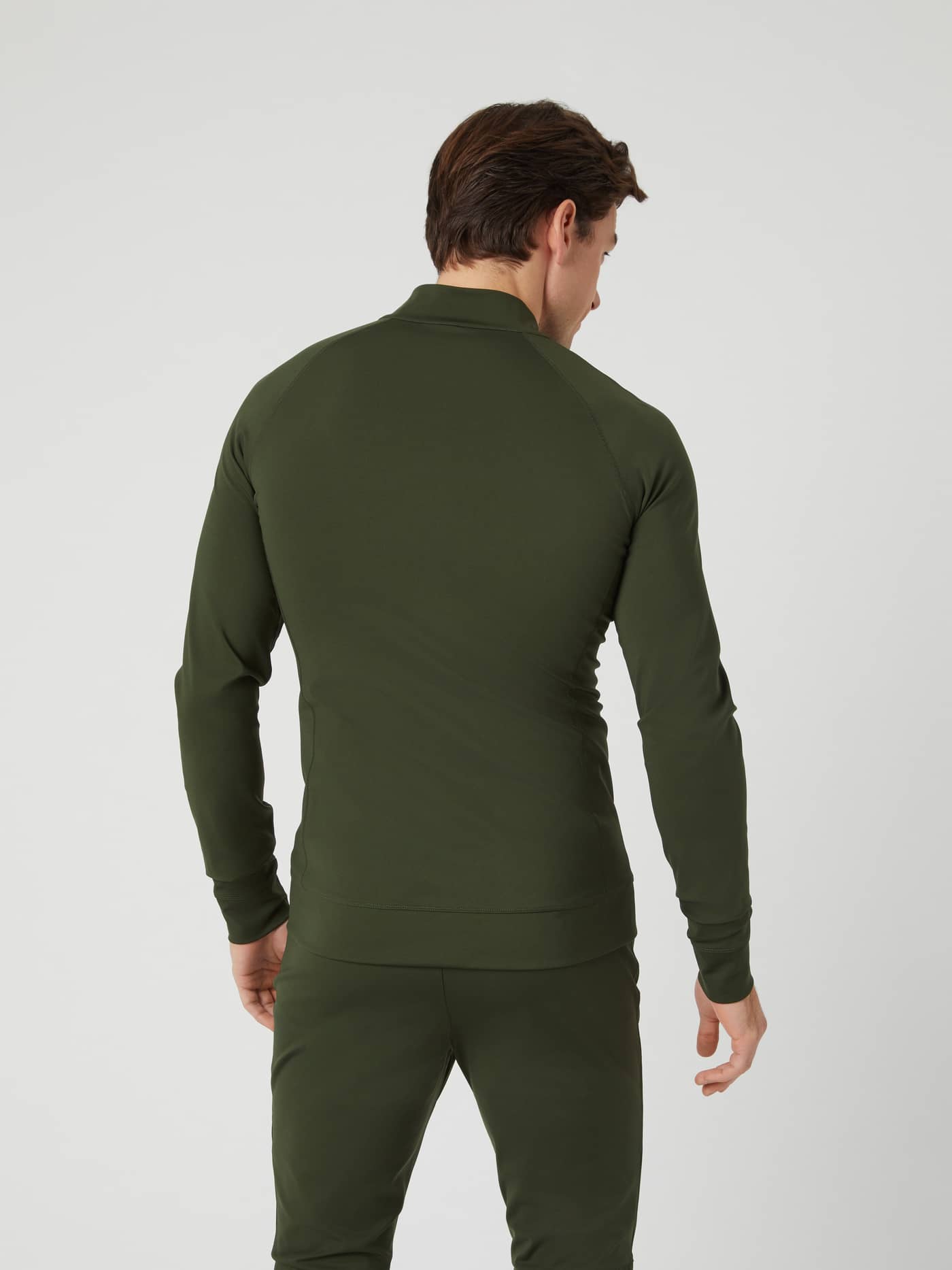 Back view of a man wearing the Borg Training Midlayer Jacket in Duffel Bag (Green), built for style and performance. - Image 2