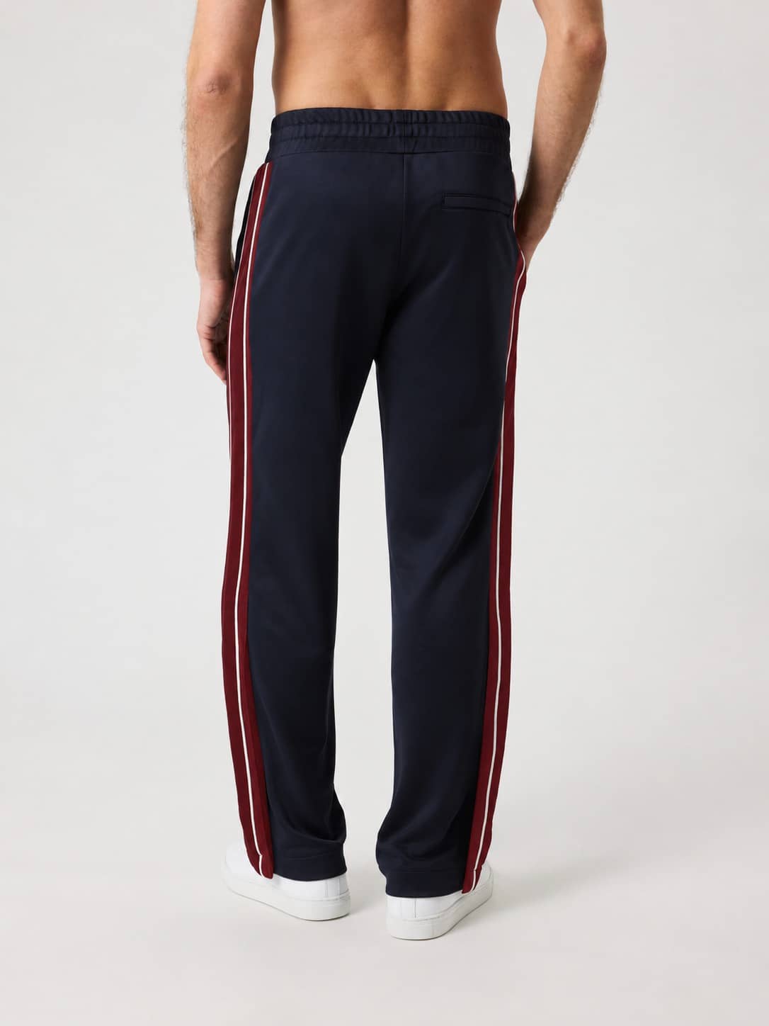 Back view of the Ace Retro Track Pants in Night sky (Navy) featuring contrasting side panels and a zippered back pocket. - Image 3