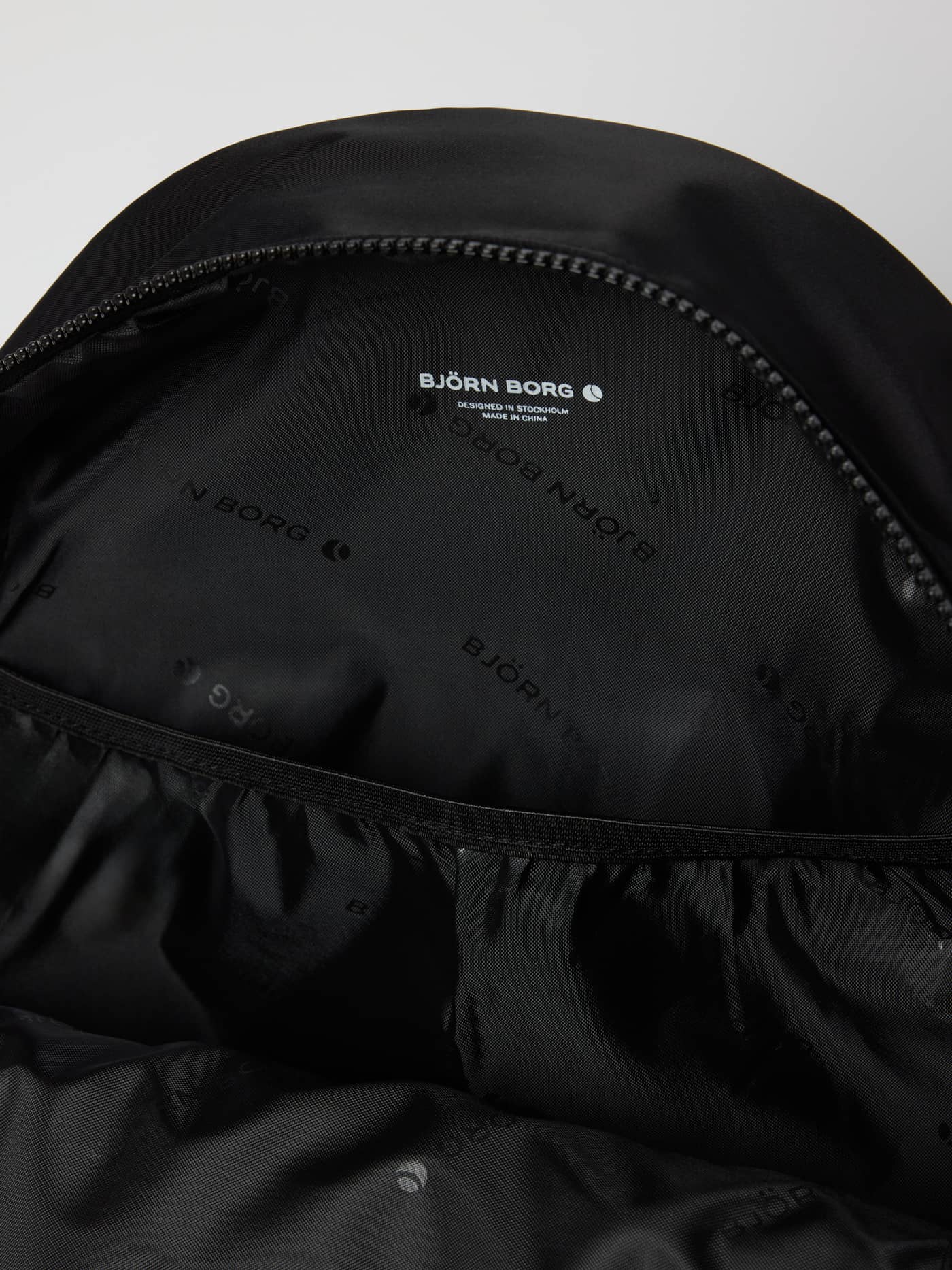Interior view of the Borg Daily Backpack 20L in Black Beauty (Black) showing the digital sleeve and recycled lining. - Image 4