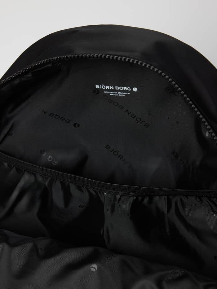 Interior view of the Borg Daily Backpack 20L in Black Beauty (Black) showing the digital sleeve and recycled lining. - Image 4