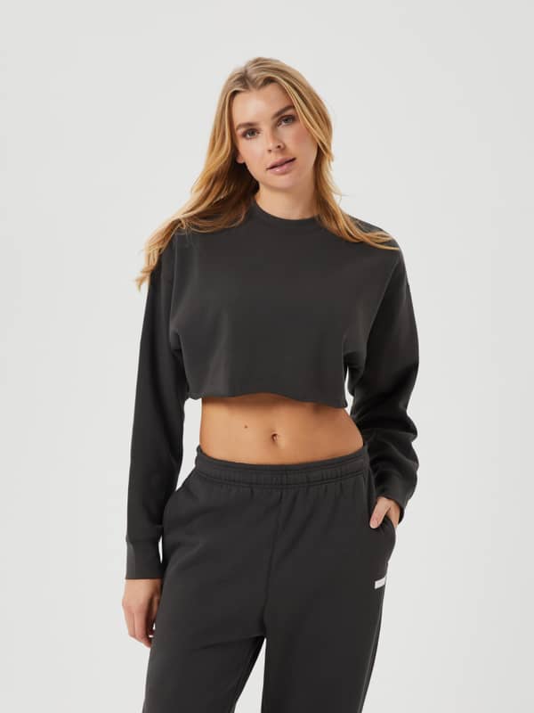 Front view of a woman wearing the Studio Oversized Cropped Crew in Peat (Green) with a cropped fit and raw edges.