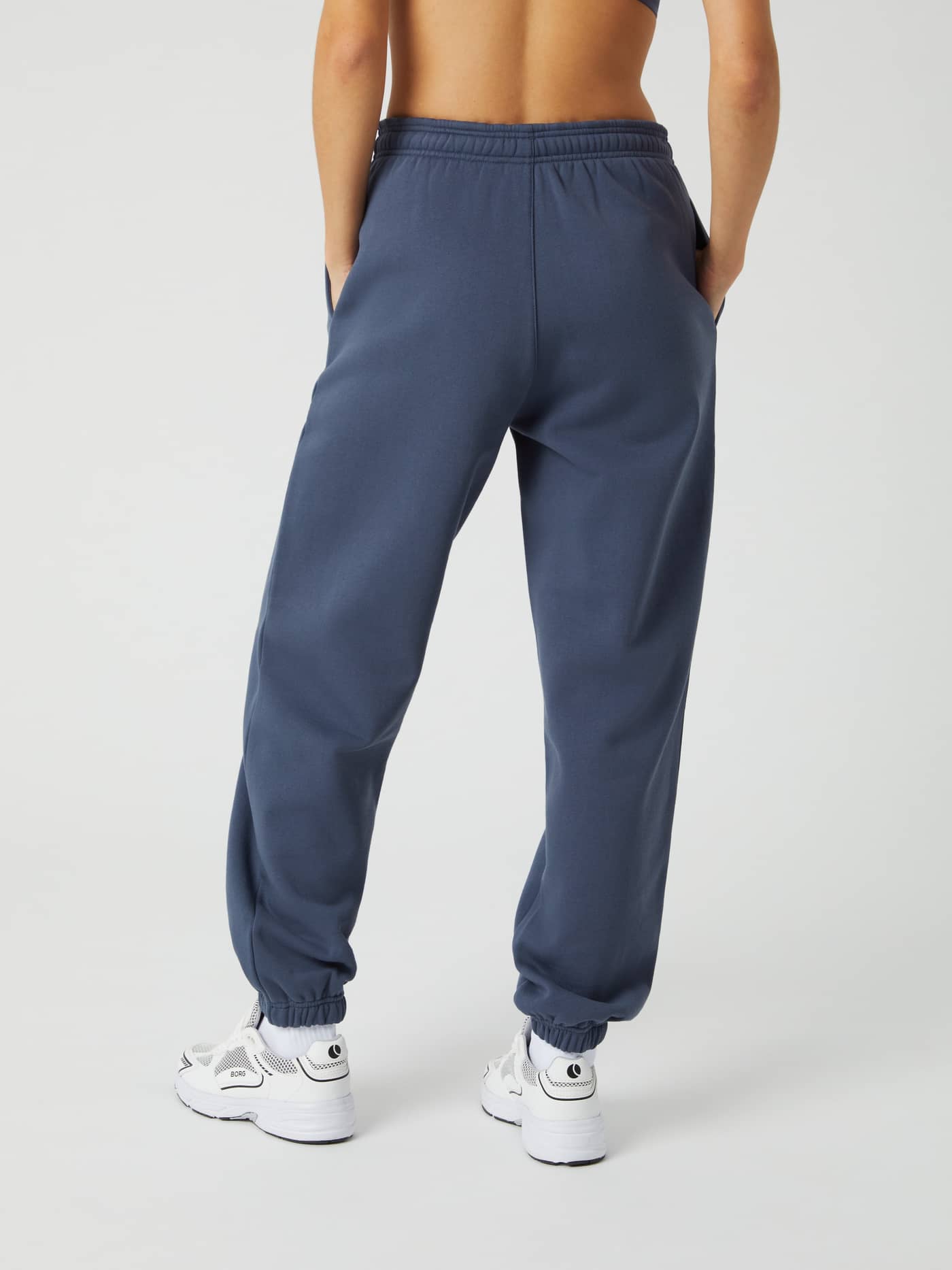 Back view of a model wearing the Björn Borg Studio Oversized Pants in Nightshadow Blue (Blue), showcasing the relaxed fit. - Image 3