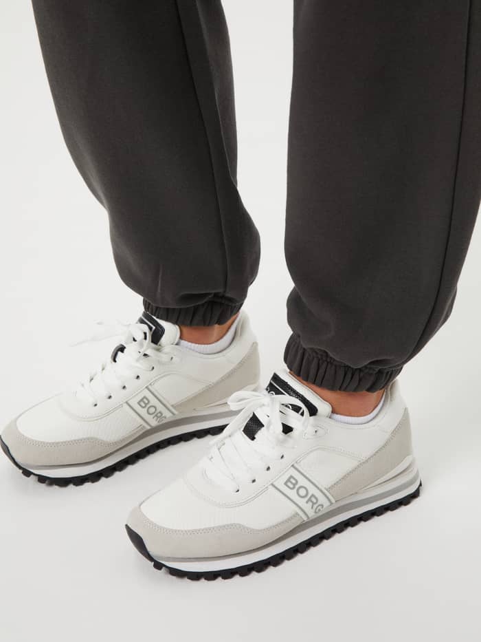 Detailed close-up of the Björn Borg Studio Oversized Pants in Peat (Green) with ribbed cuffs for a stylish training fit.