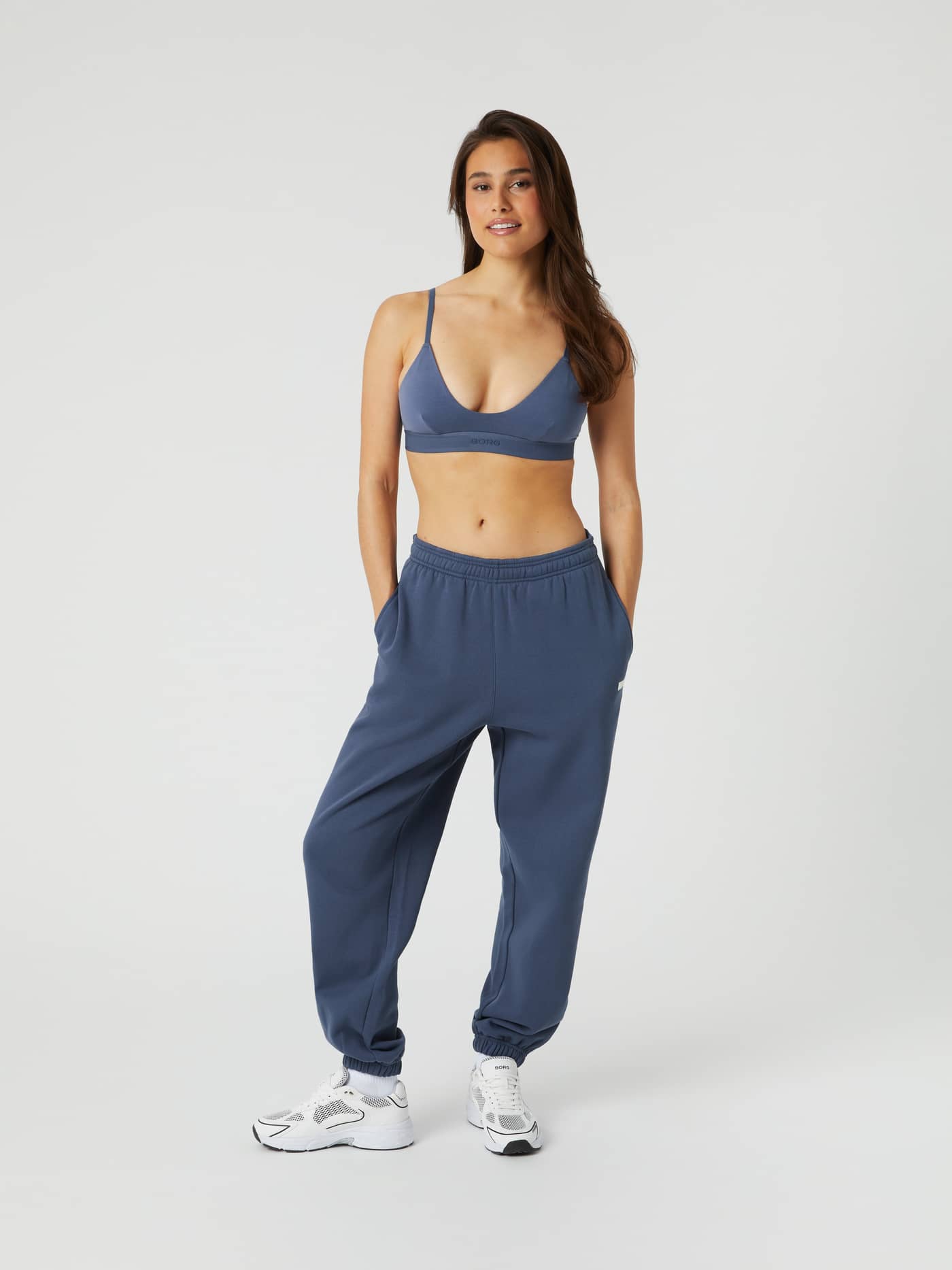 Full-body front view of a woman wearing the Björn Borg Studio Oversized Pants in Nightshadow Blue (Blue) with a relaxed fit. - Image 1
