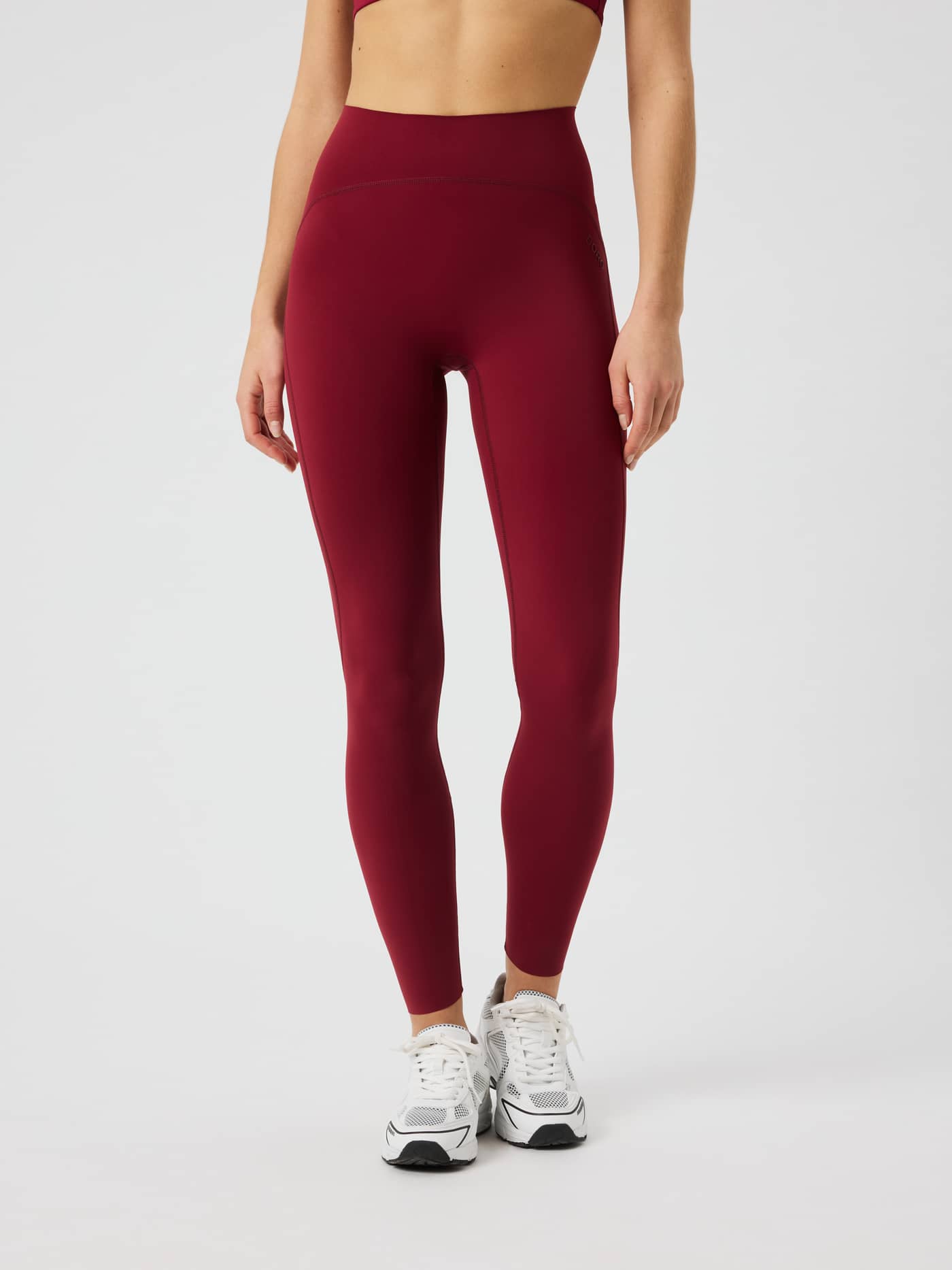 Front view of the Borg Sleek Tights in Cabernet (Red) for training, featuring a high waist and slim fit. - Image 2