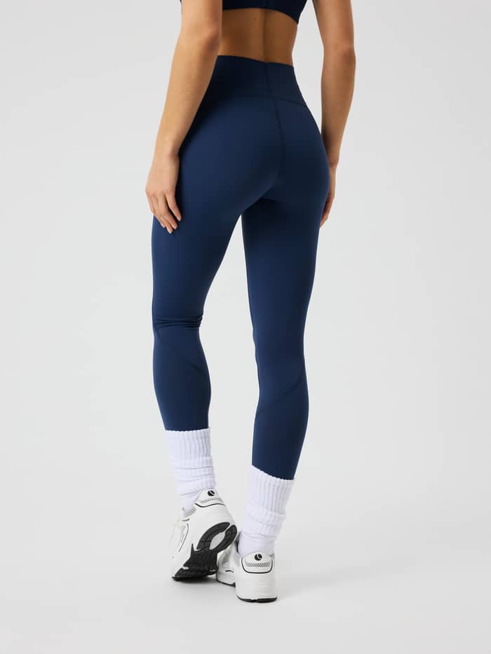 Back view of the Borg Sleek Tights in Dress Blues for training, featuring a high waist and slim fit.