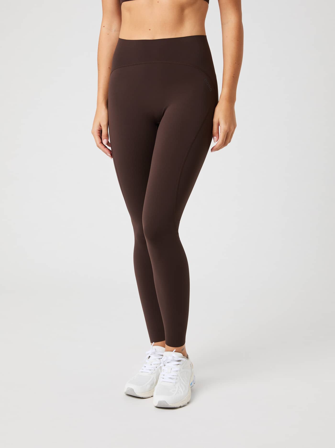 Model from the front wearing the brown Borg Sleek Tights. - Image 1