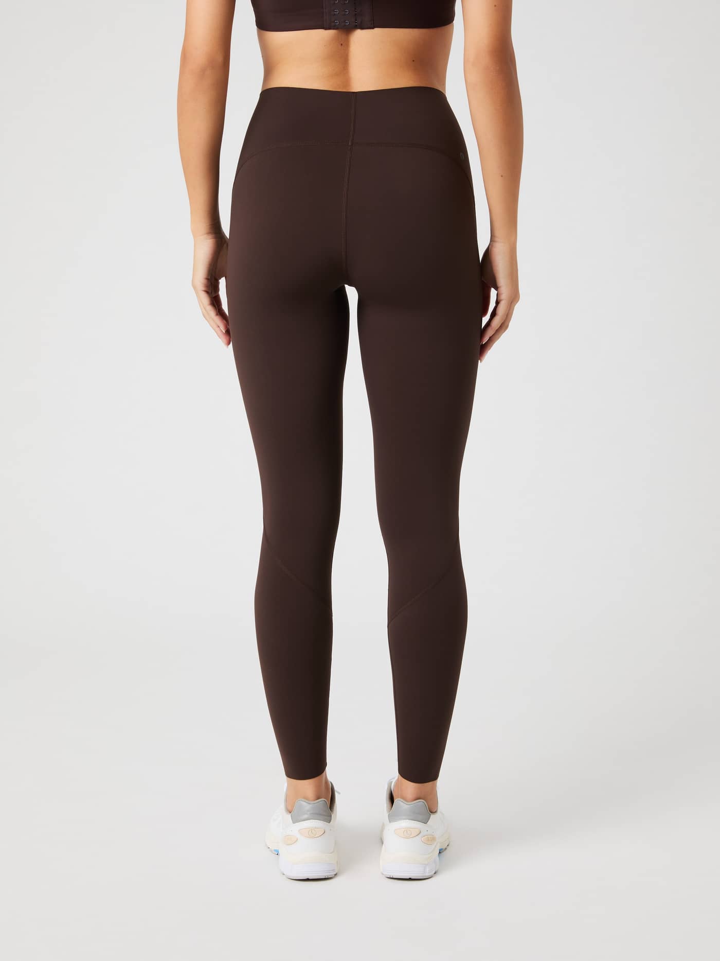 Back view of a model wearing the brown Borg Sleek Tights. - Image 2