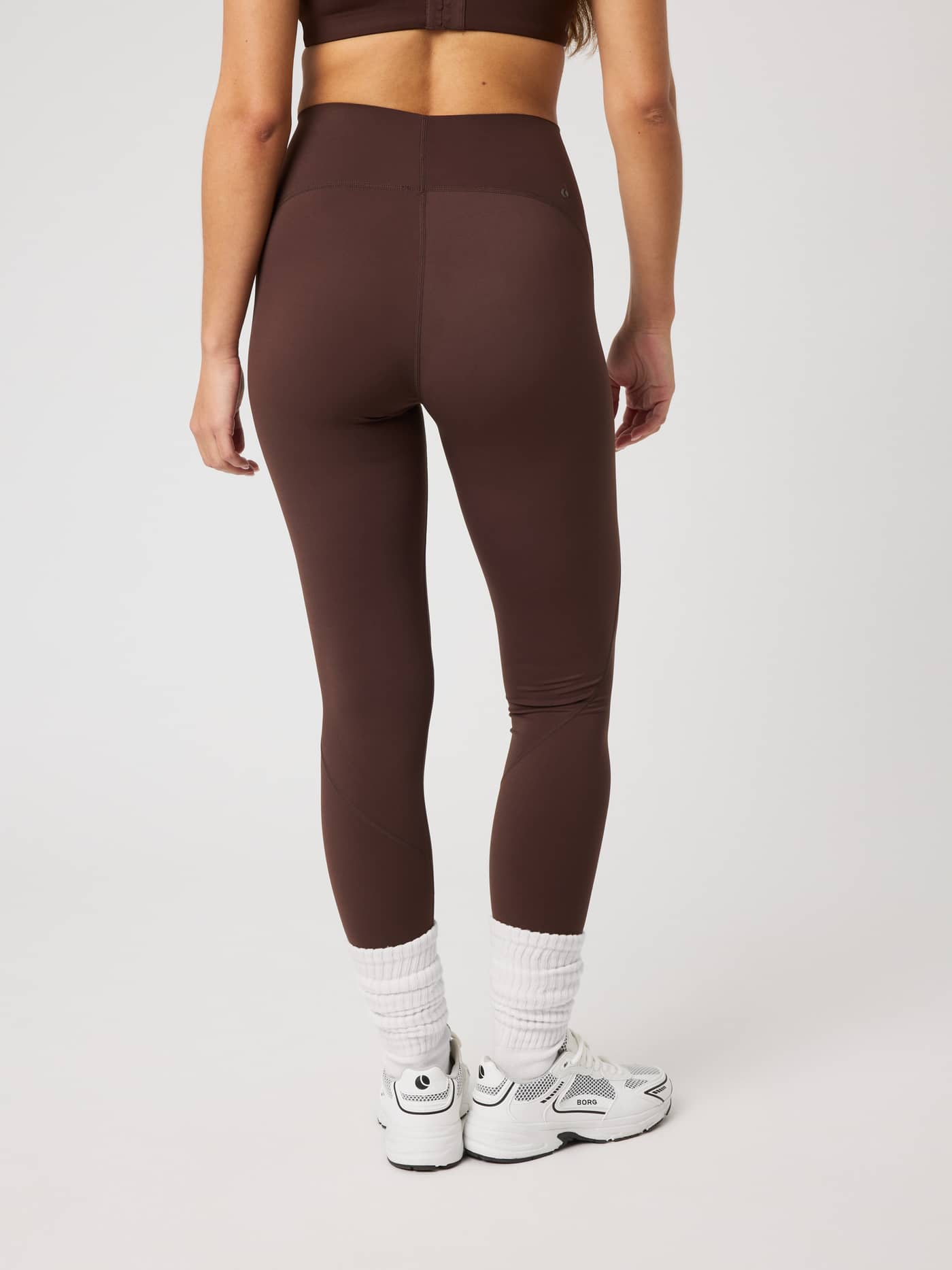 Back view of the slim fit Borg Sleek Tights in Coffee Bean (Brown) featuring a high waist for premium training support. - Image 2