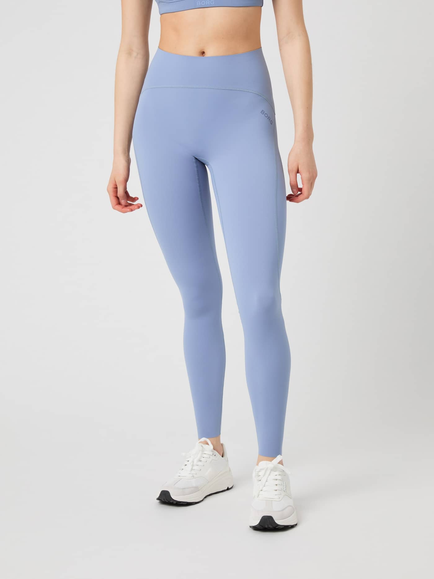 Model wearing the Borg Sleek Tights in stonewash, seen from the front. - Image 1