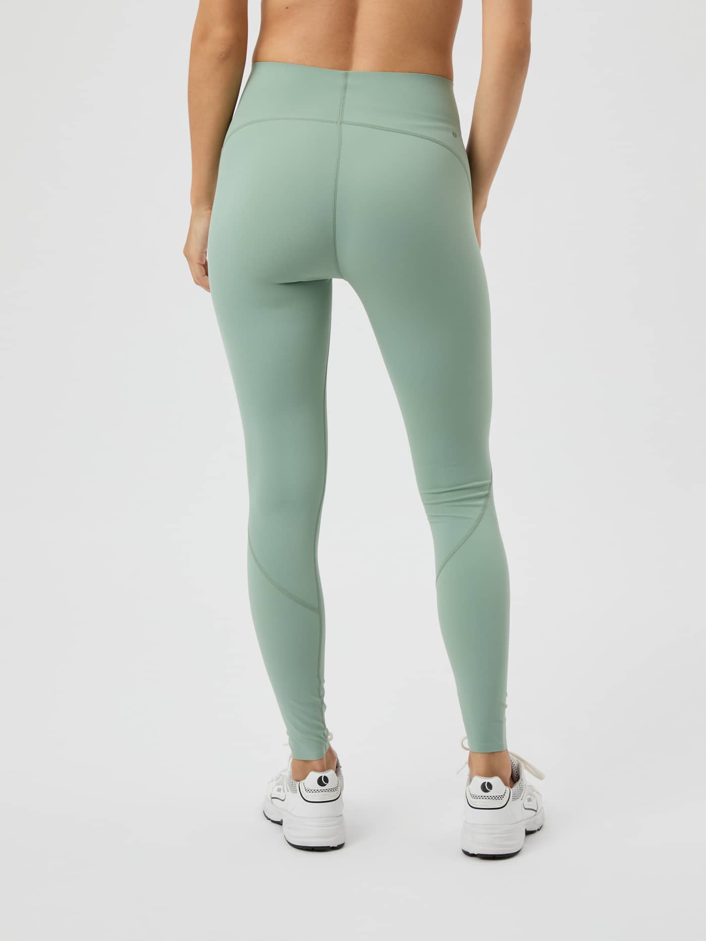 Back view of a model wearing the Björn Borg Borg Sleek Tights in Lily Pad. - Image 3