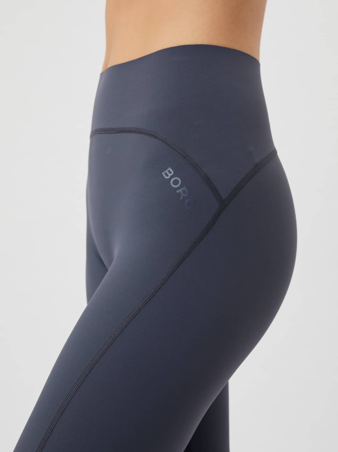 Detailed side view of the Borg Sleek Tights in Odyssey Gray, focusing on the high-waisted fit and tonal BORG logo. - Image 4