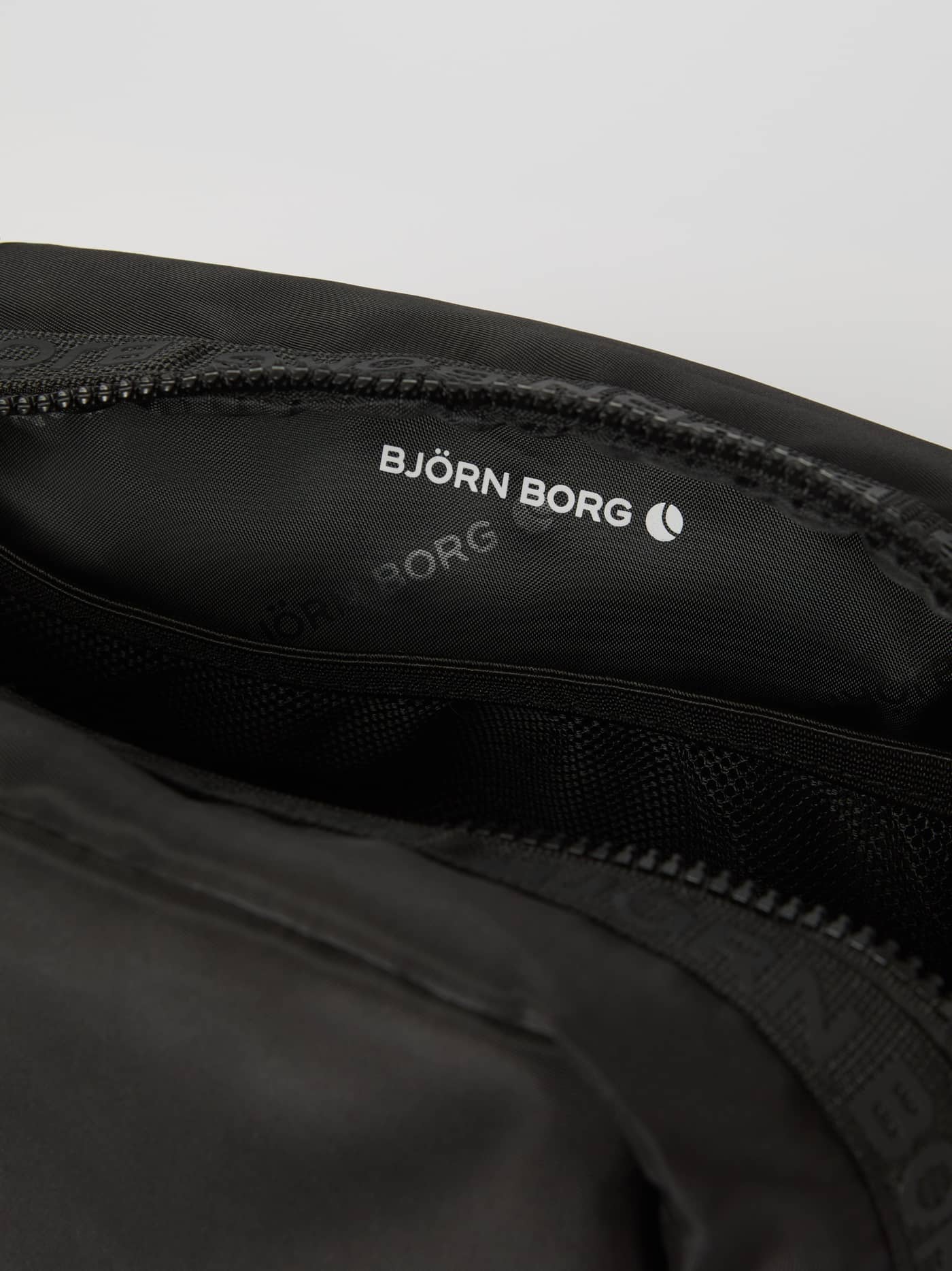 Interior view of the Borg Classic Toilet Case in Black Beauty (Black), featuring the white logo and internal mesh pocket. - Image 3