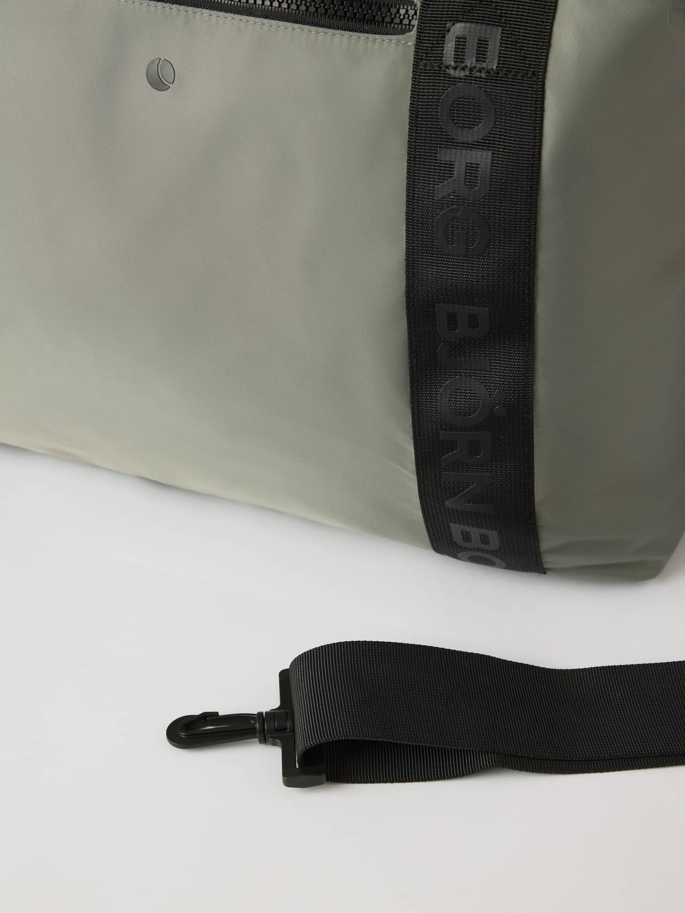 Close-up of the Agave Green (Green) Borg Classic Sports Bag 28L with black branded straps and a detachable training strap. - Image 4