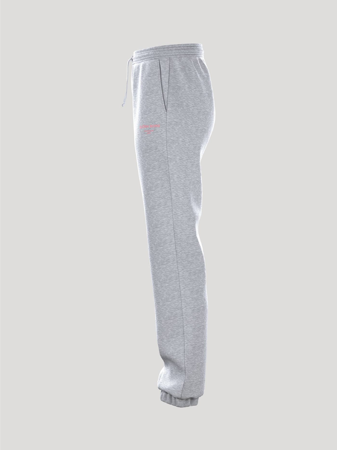 Side profile of the women's Borg Essential 1 Pants in Light Grey Melange (Grey) featuring a pink logo and a loose fit. - Image 4