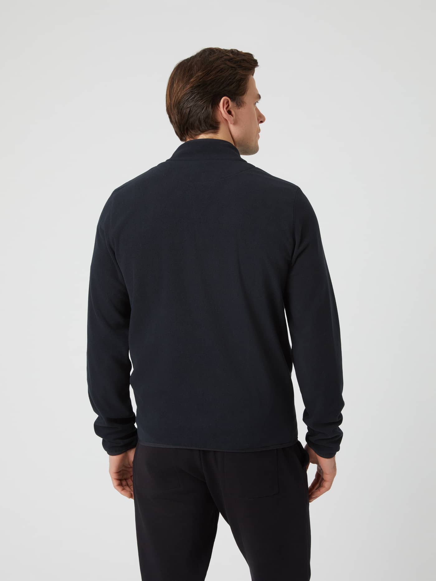 Back view of a man wearing the black Borg Full Zip Fleece jacket. - Image 3