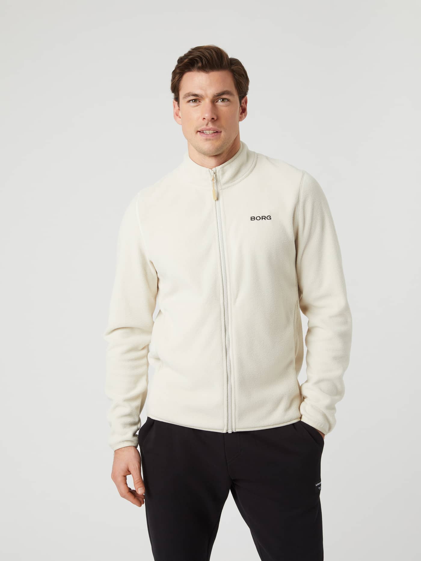 Front view of a model wearing the Borg Full Zip Fleece in Silver Birch. - Image 1