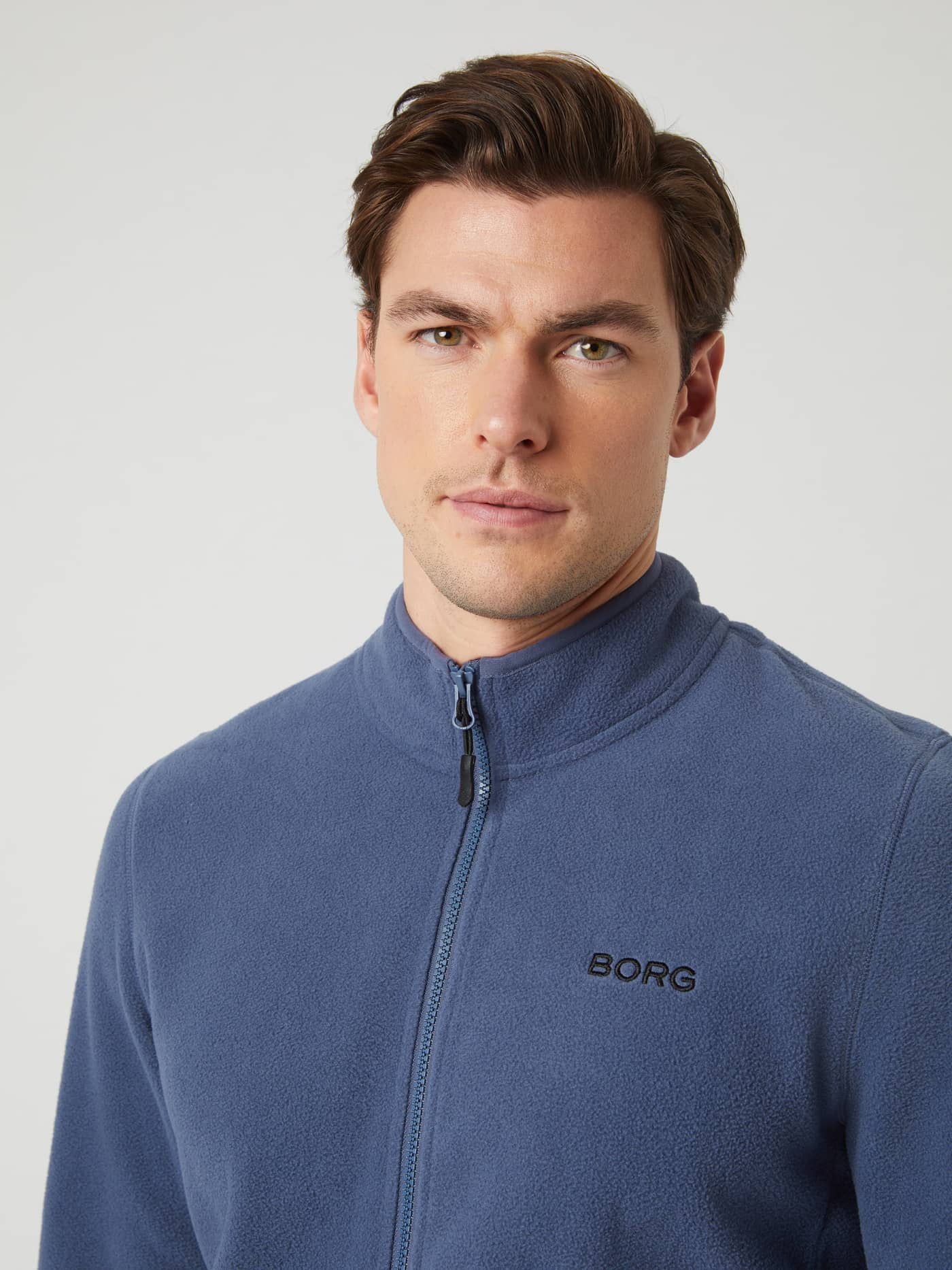 Front close-up of a man wearing the Borg Full Zip Fleece in Nightshadow Blue. - Image 4