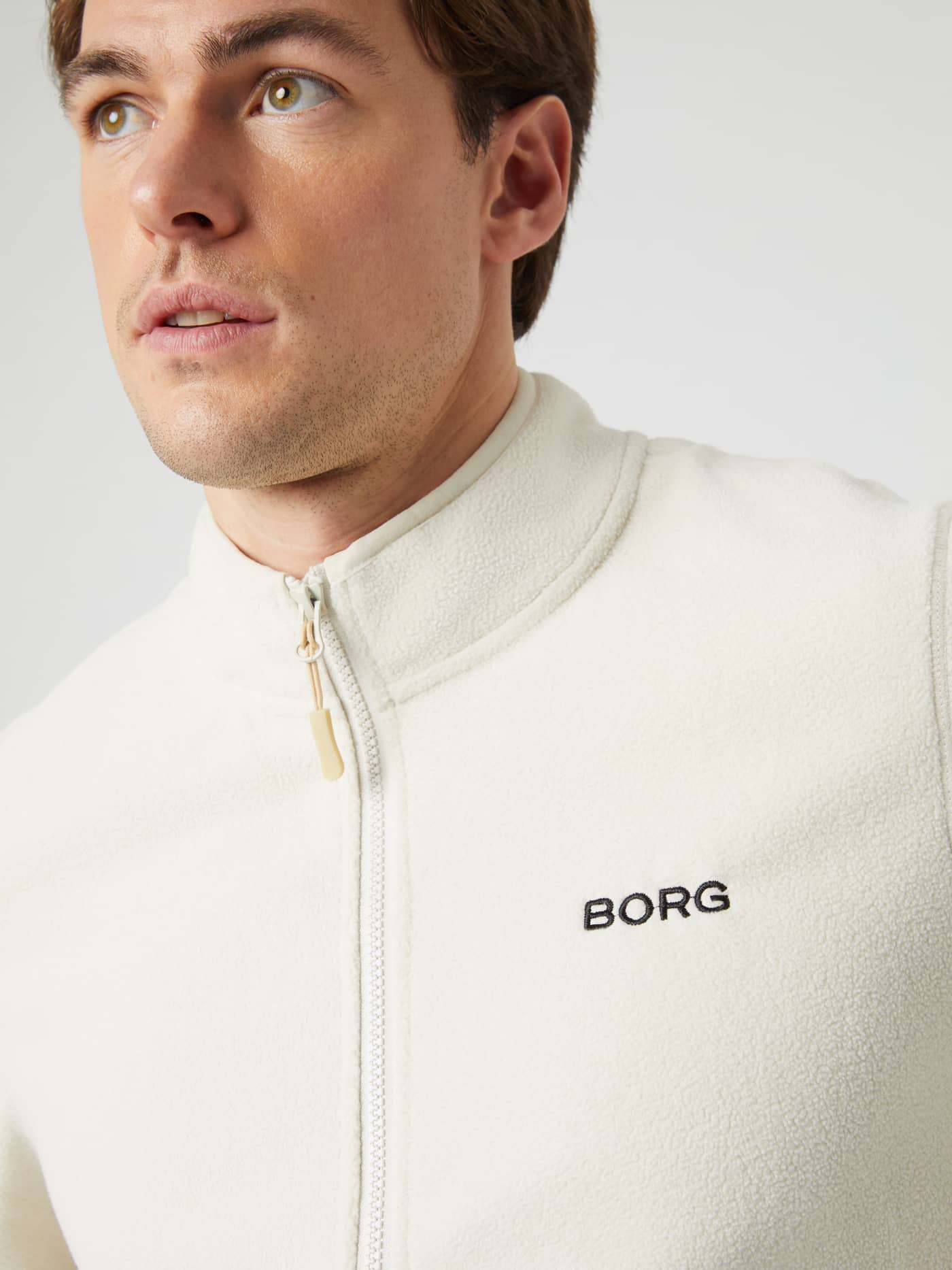Close-up of the Borg Full Zip Fleece in Silver Birch on a model, showing the collar and chest logo. - Image 6