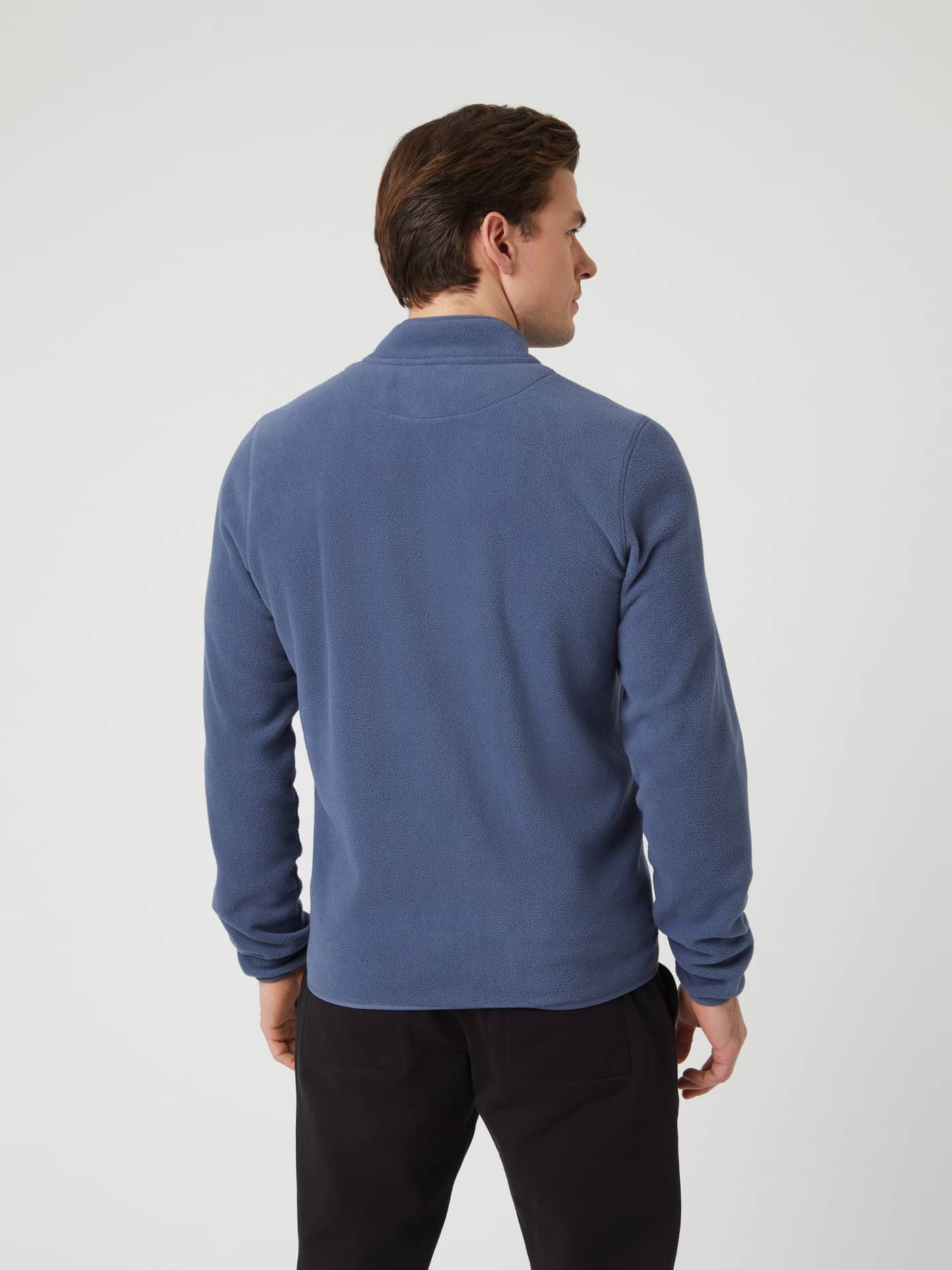 Back view of a model wearing the Borg Full Zip Fleece in Nightshadow Blue. - Image 2