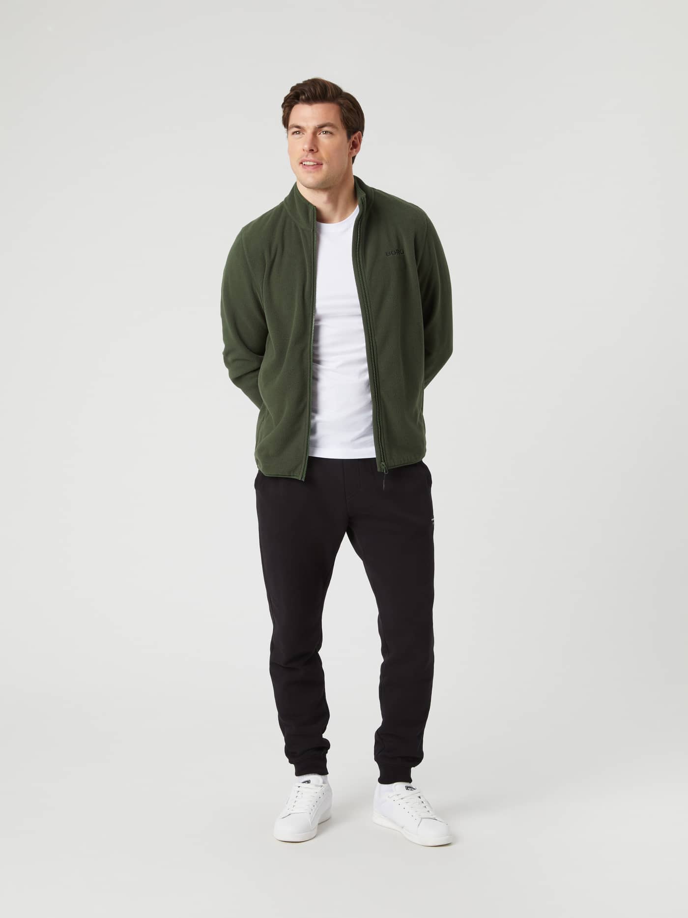 Full length front view of a man wearing the Björn Borg Borg Full Zip Fleece jacket in Duffel Bag green. - Image 3