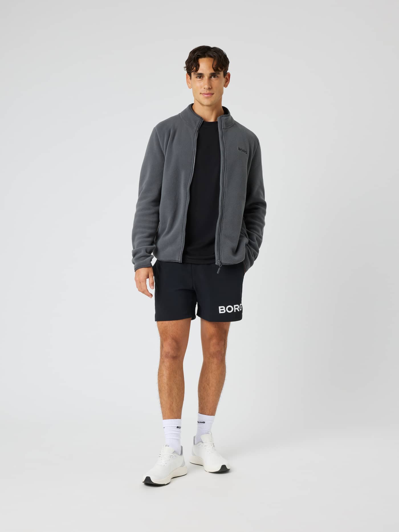Full-body view of a model wearing the Borg Full Zip Fleece in Asphalt (Black) for training and tennis. - Image 3