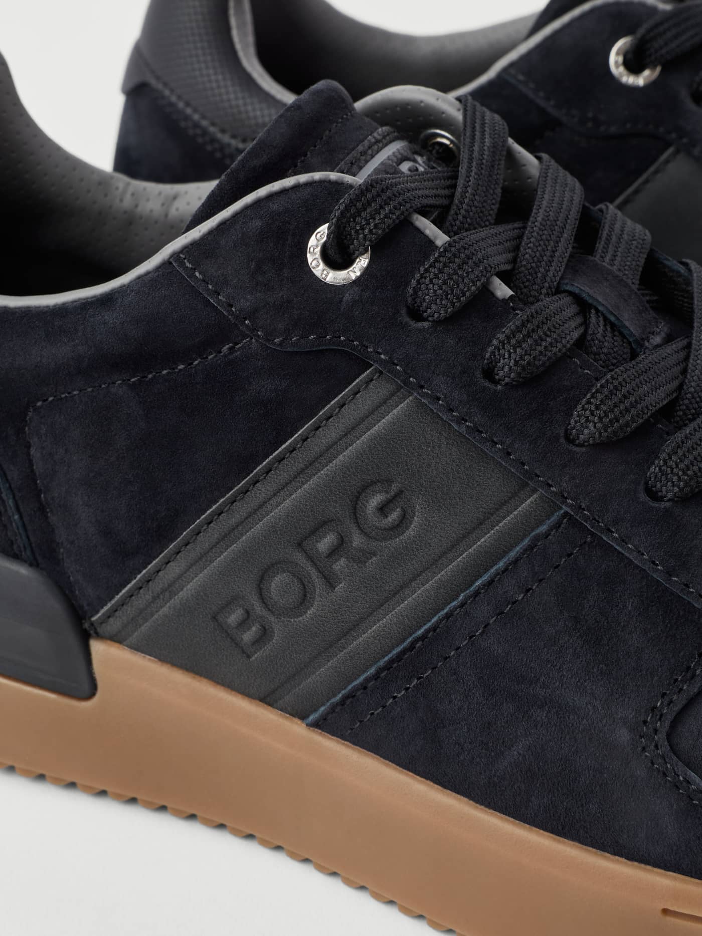 Close-up of the Björn Borg Men's Spin Sneakers in Black with suede, a black embossed logo, and a tennis-inspired gum sole. - Image 3