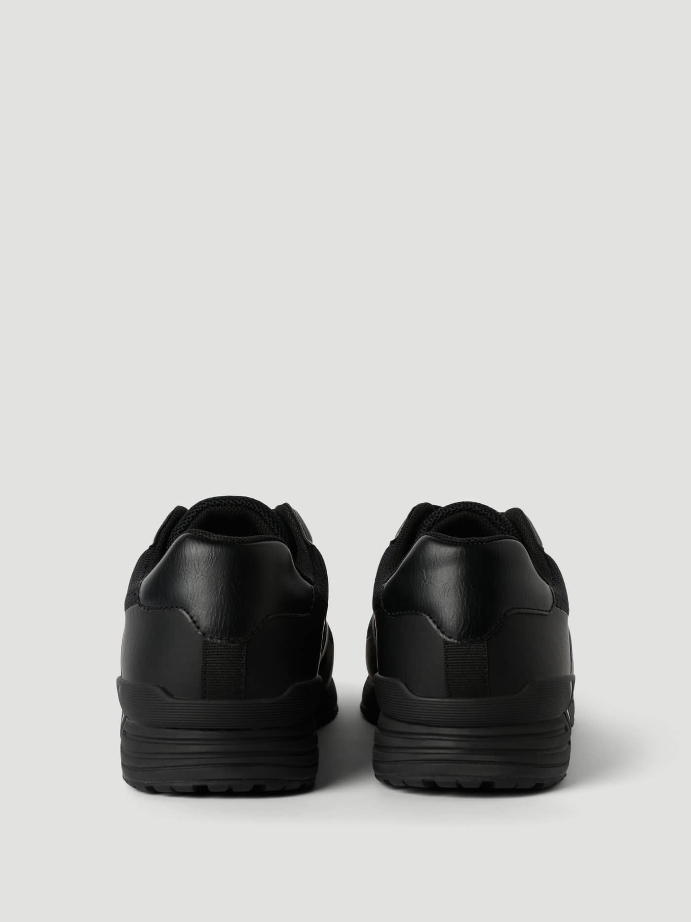 Rear view of the black Men's Match Sneakers, featuring functional synthetic leather and mesh for running. - Image 2