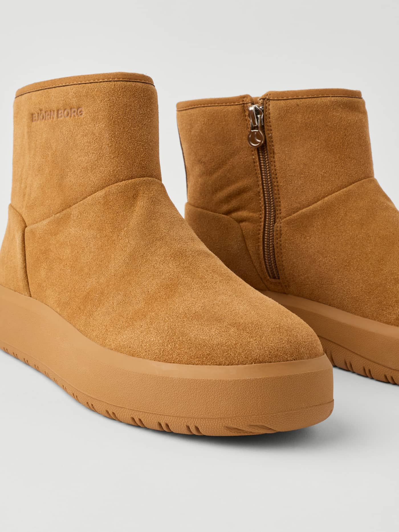 Close-up of the Women's Wooly Boots in Brown featuring a high-top design, side zipper, and a thick grippy rubber sole. - Image 5