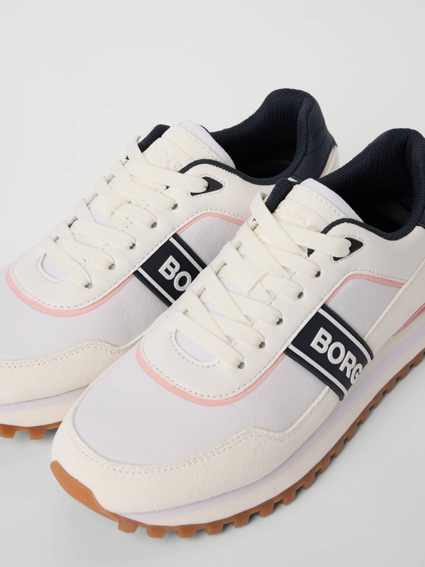 Close-up of Women's Dash Sneakers in White synthetic leather for running, with a white BORG logo and stylish performance. - Image 2