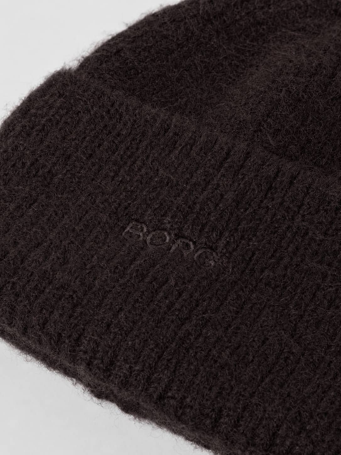 Close-up of the Studio Beanie in Coffee Bean (Brown) showing the soft knitted fabric and tonal Borg logo embroidery. - Image 2