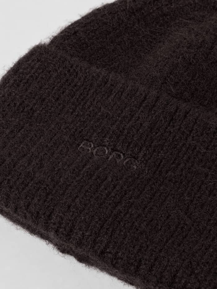 Close-up of the Studio Beanie in Coffee Bean (Brown) showing the soft knitted fabric and tonal Borg logo embroidery. - Image 2