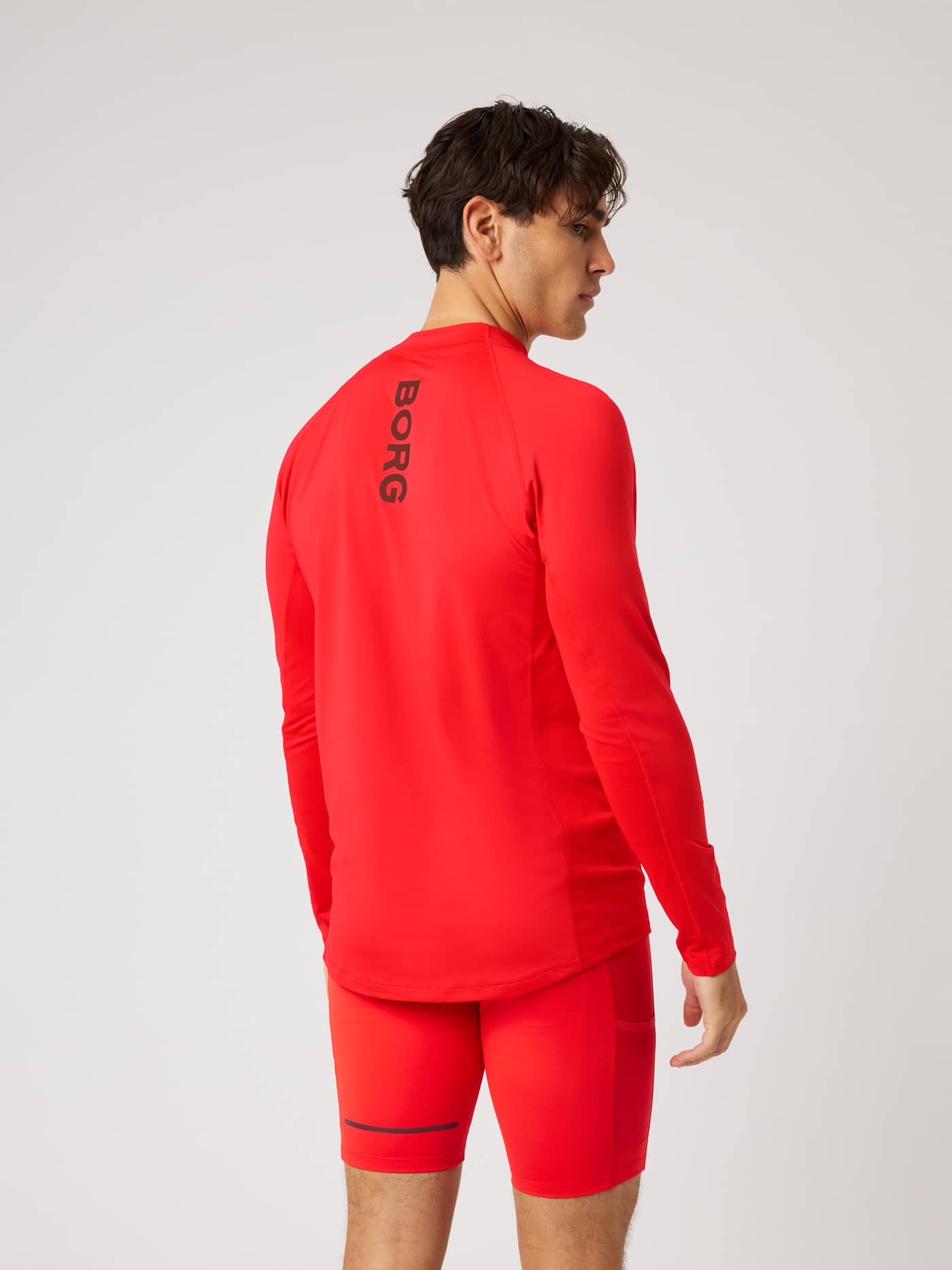 Back view of the Borg Mock Neck Ls T-Shirt in Flame Scarlet (Red) for training, featuring a black BORG logo print. - Image 2